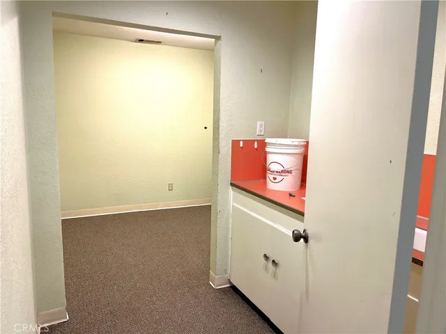 a utility room with closet and mirror