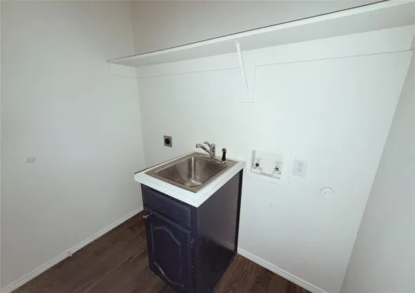 a utility room with a sink washer and dryer