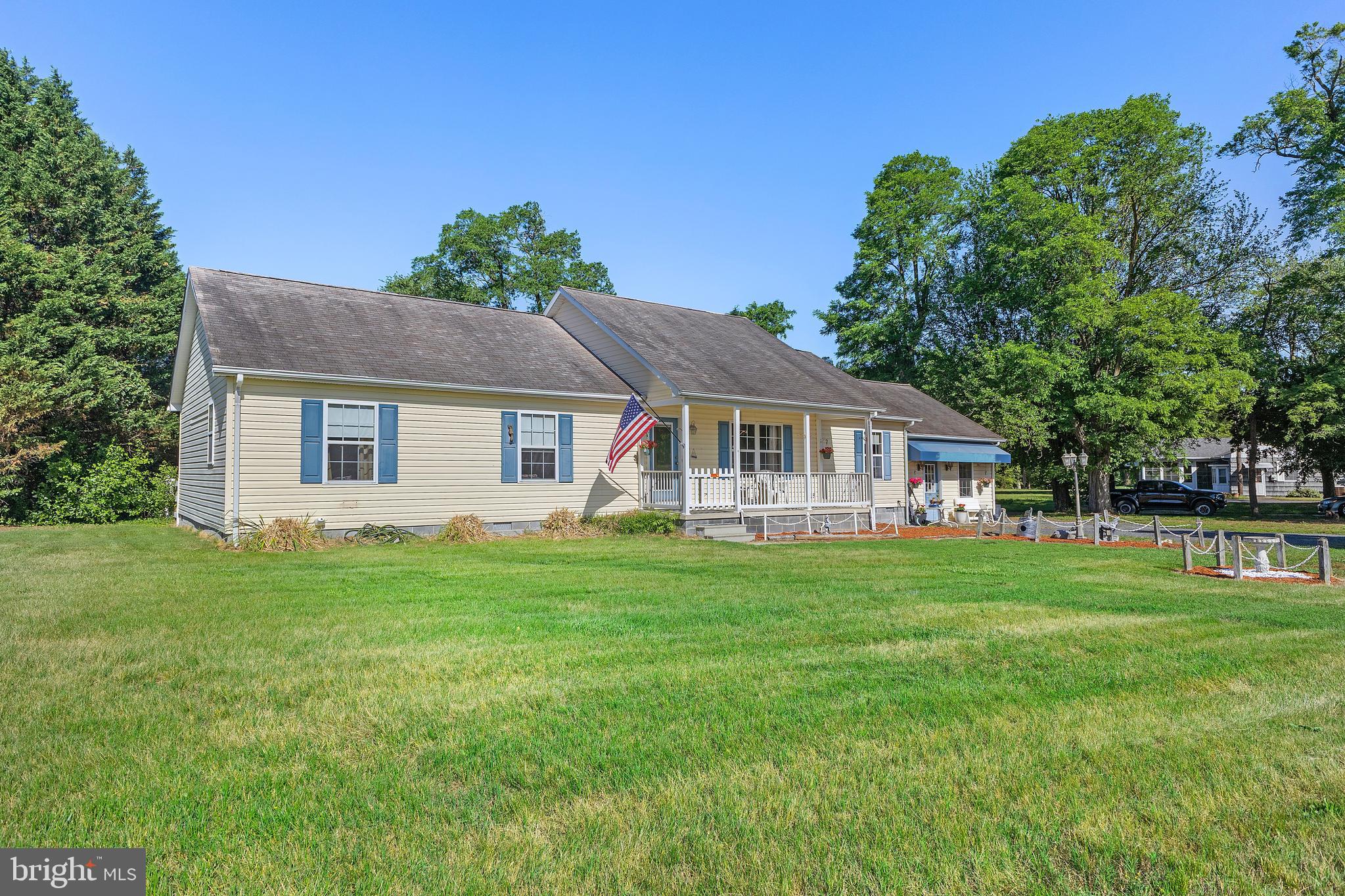 7112 East New Market Ellwood Road Hurlock, MD 21643 - Photo 1 of 41 a front view of a house with a garden
