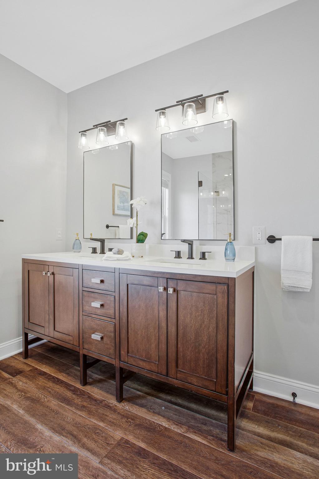 6146 Drum Point Road Deale, MD 20751 - Photo 40 of 75 a spacious bathroom with a double vanity sink and a mirror