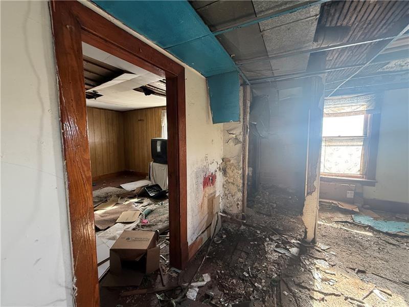 189 Beaver Street Leetsdale, PA 15056 - Photo 13 of 14 a view of a hallway with wooden walls and windows