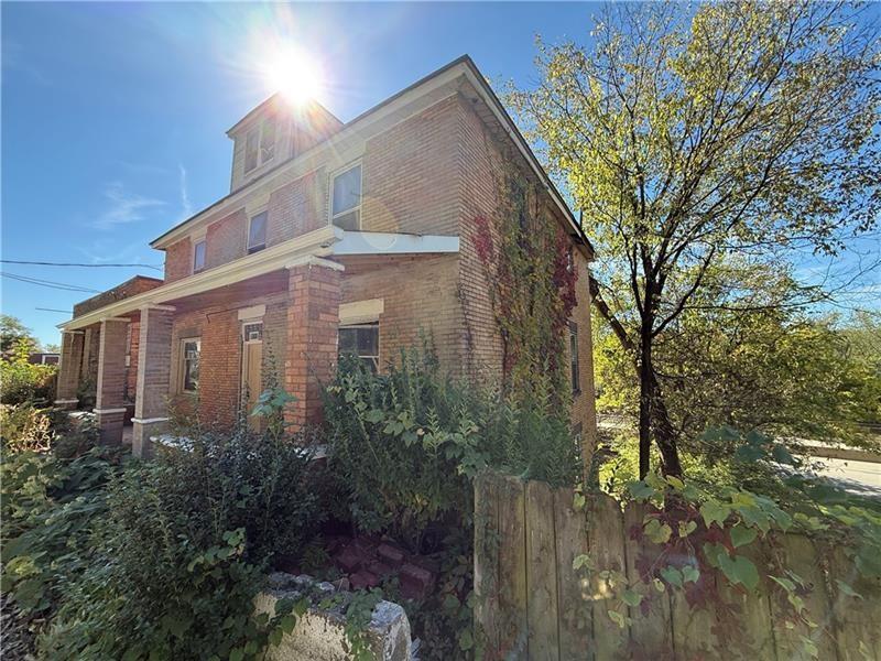 189 Beaver Street Leetsdale, PA 15056 - Photo 2 of 14 a front view of a house with plants and trees