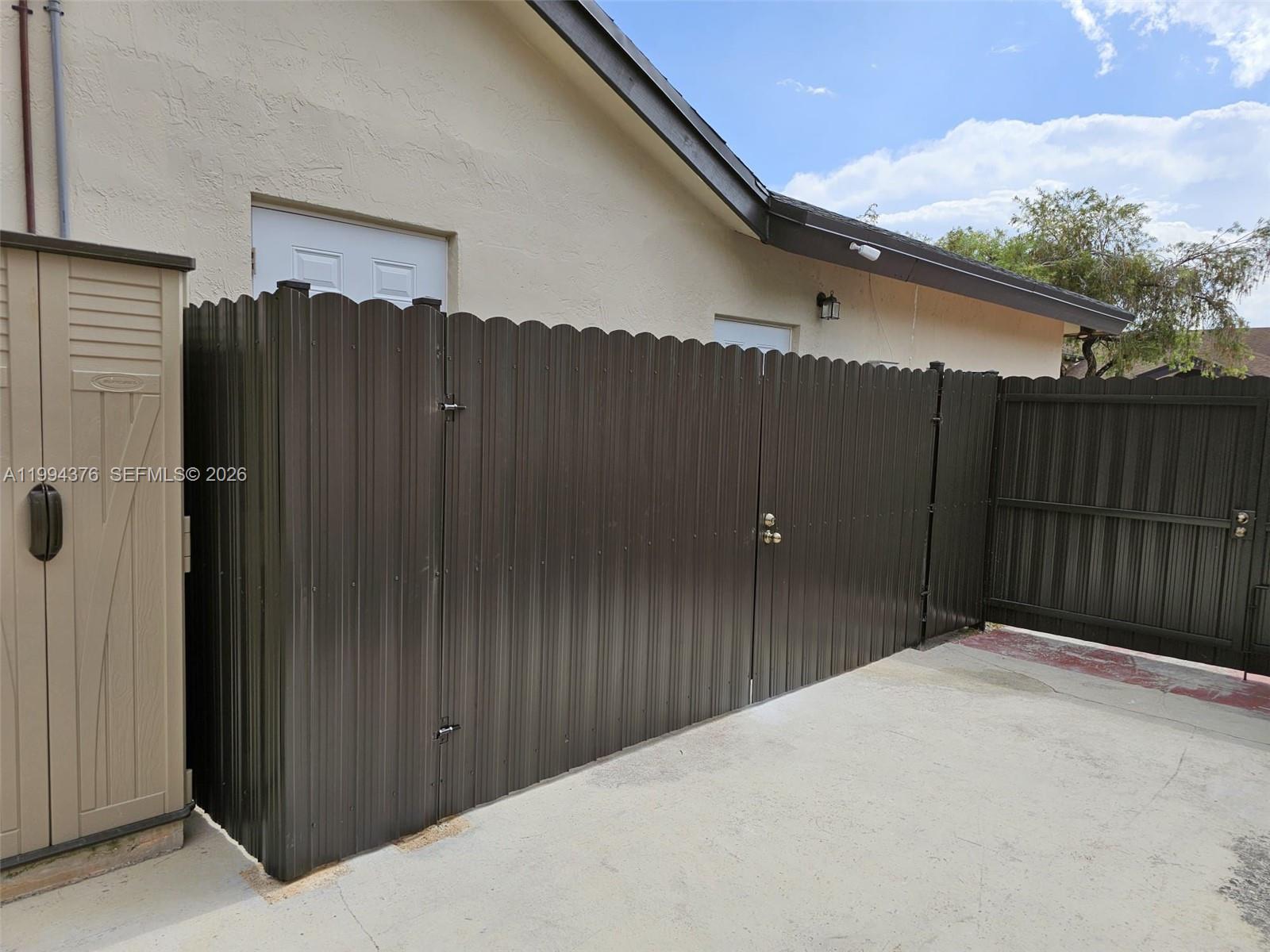 10825 Southwest 145th Place, Unit 2 Miami, FL 33186 - Photo 6 of 6 a backyard of a house