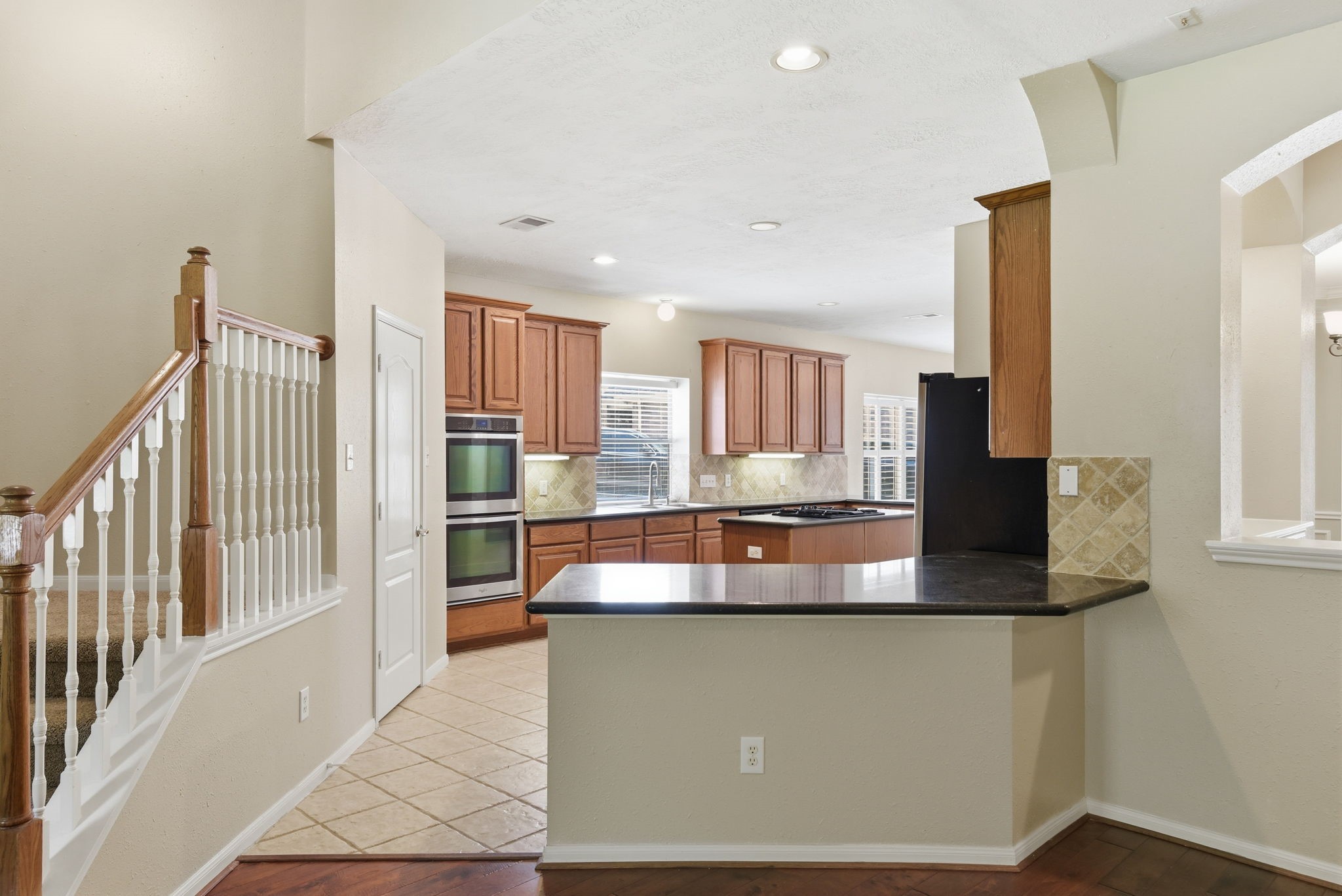3414 Hackberry Court Spring, TX 77388 - Photo 14 of 50 Let's check out this awesome kitchen! Granite counter tops, tile backsplash, stainless steel appliances, gas cooktop!