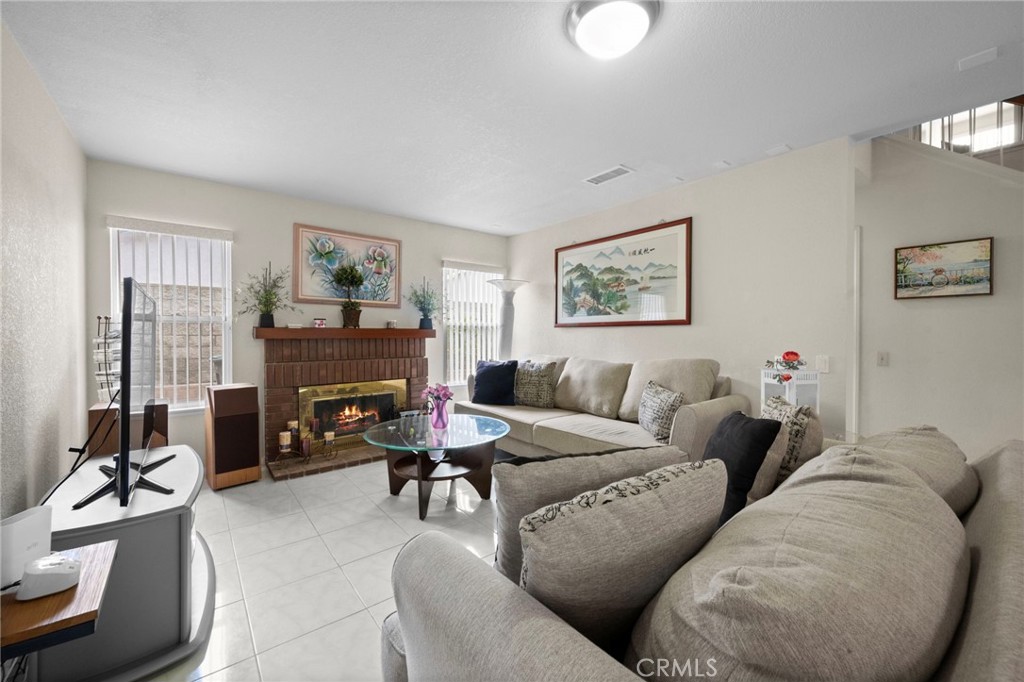 605 Bronco Way Walnut, CA 91789 - Photo 24 of 69 a living room with furniture a fireplace and a window