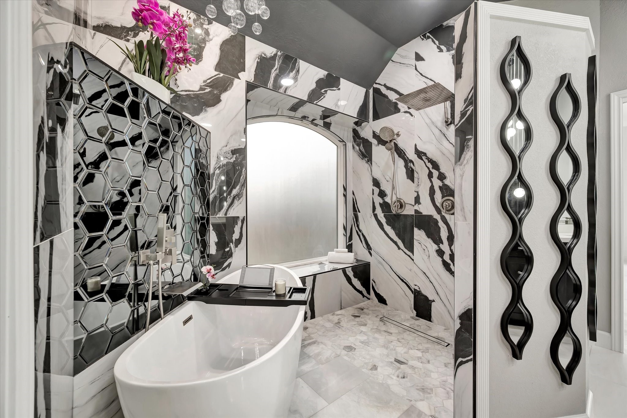 2847 Everett Drive Friendswood, TX 77546 - Photo 36 of 50 This luxurious bathroom features a sleek freestanding tub and a spacious walk-in shower. Elegant hexagonal tile accents and contemporary decor add a touch of sophistication.