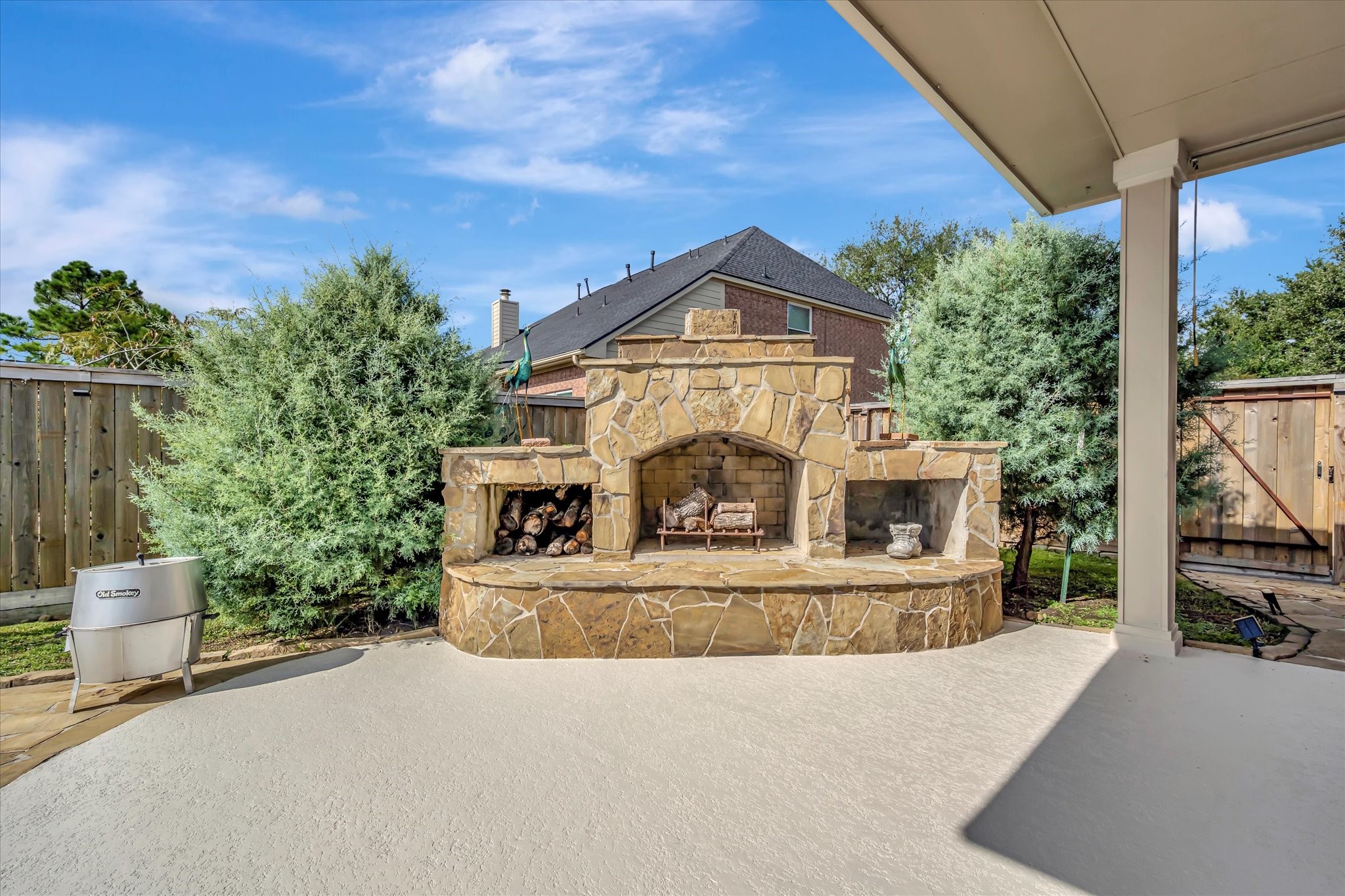2847 Everett Drive Friendswood, TX 77546 - Photo 4 of 50 Cozy outdoor stone fireplace, perfect for entertaining or relaxing evenings under the stars.