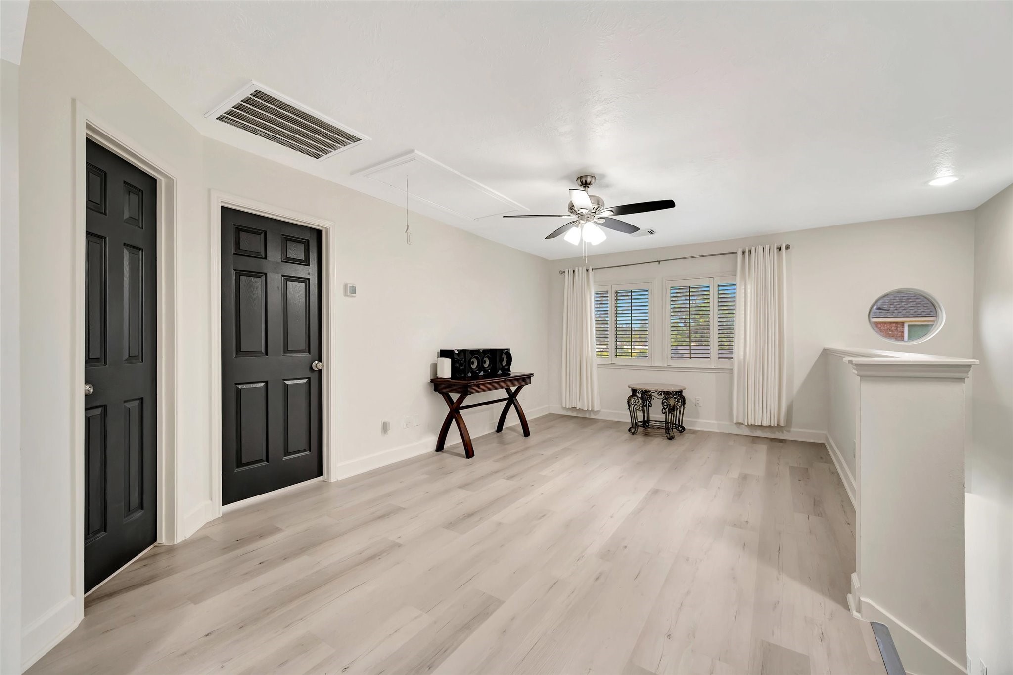 2847 Everett Drive Friendswood, TX 77546 - Photo 44 of 50 This bright and airy game room features light wood flooring and neutral walls, complemented by two dark doors.