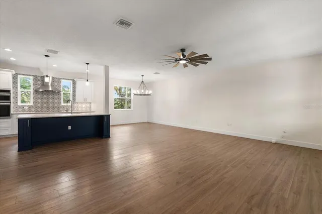 a view of a kitchen with a sink and a large window