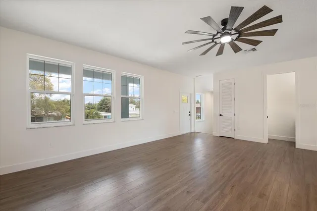 wooden floor in an empty room with a window