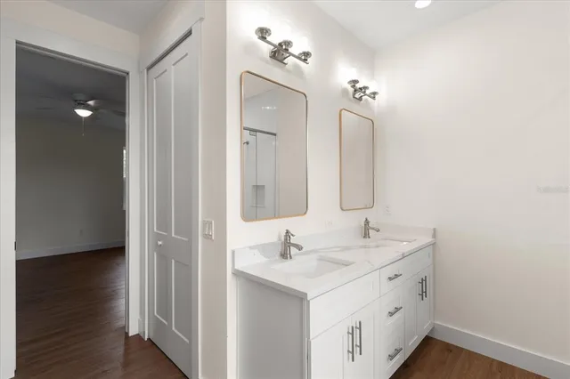 a bathroom with a double vanity sink and mirror