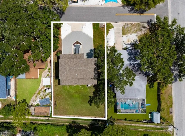 an aerial view of a house with a yard