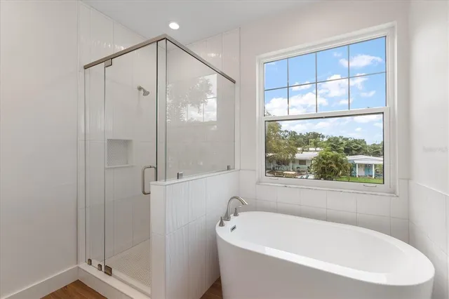 a white bath tub sitting next to a window