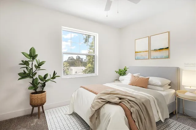 a bedroom with a bed and a potted plant