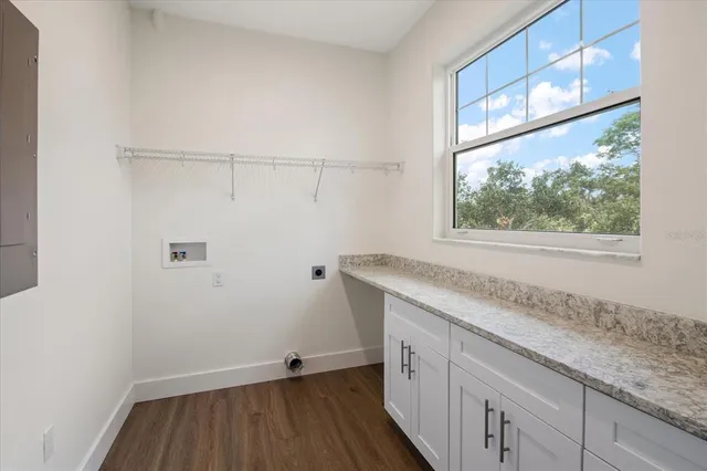 a view of a kitchen with wooden floor and a window