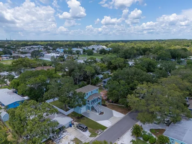 an aerial view of a house with a yard