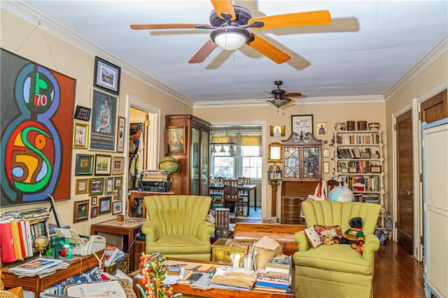 a living room with patio chairs and a chandelier