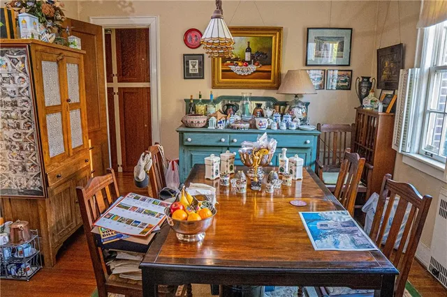 a view of a dining room with furniture and a chandelier