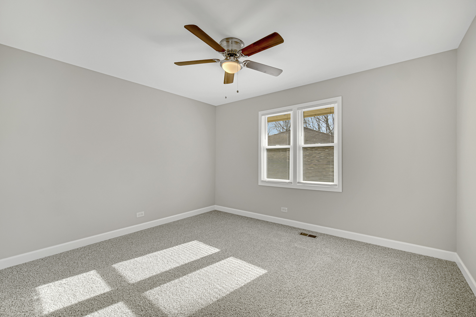 30 Cornwall Drive Crete, IL 60417 - Photo 16 of 44 an empty room with window and ceiling fan