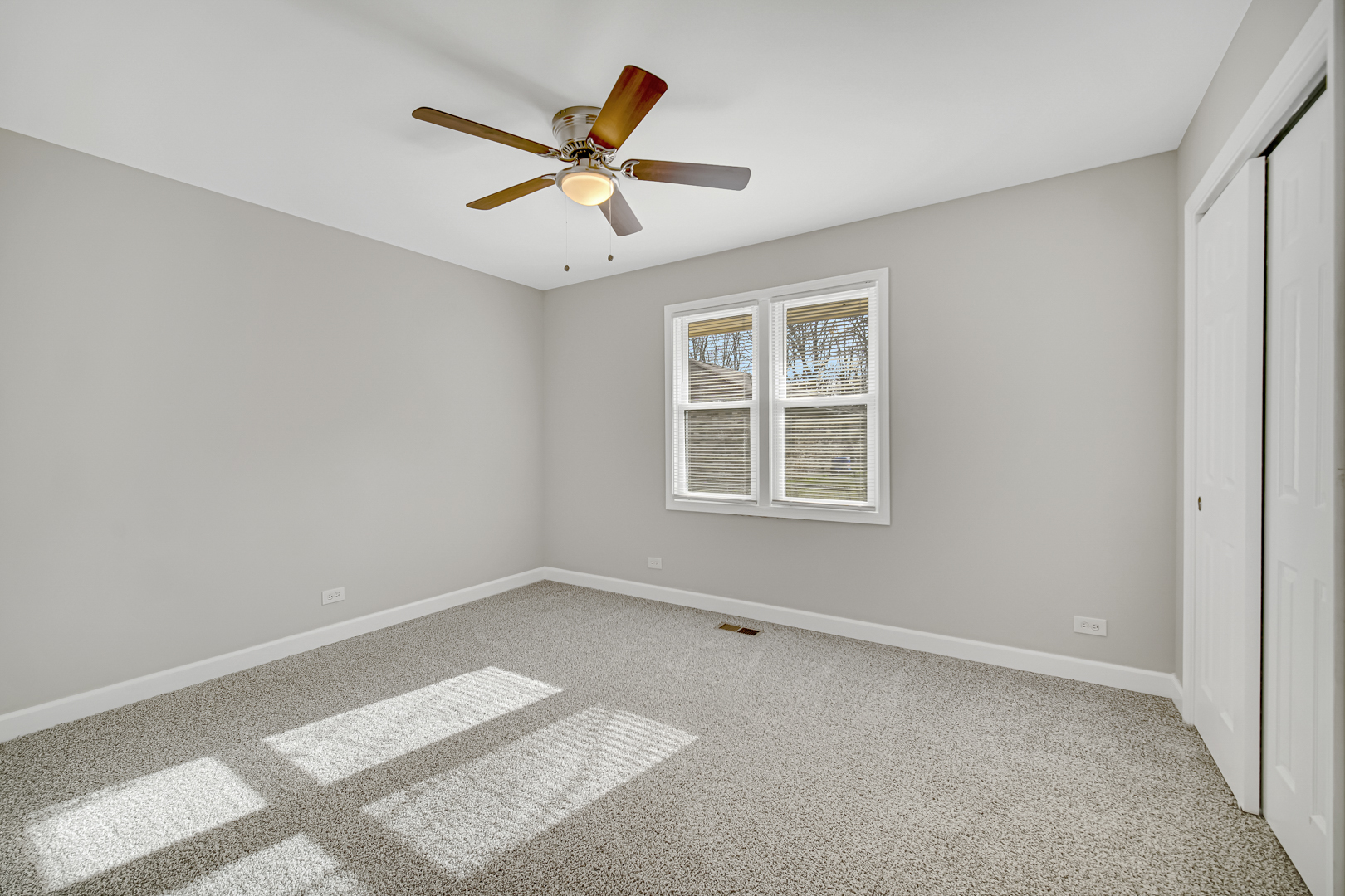 30 Cornwall Drive Crete, IL 60417 - Photo 17 of 44 an empty room with windows and fan