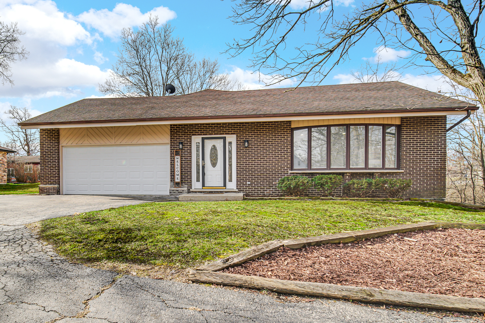 30 Cornwall Drive Crete, IL 60417 - Photo 2 of 44 a front view of a house with a yard and garage