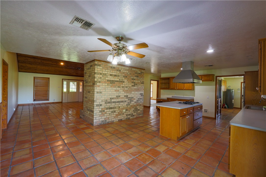 16403-16515 Macey Road Hearne, TX 77859 - Photo 25 of 46 a open kitchen with granite countertop a stove top oven a sink and dishwasher