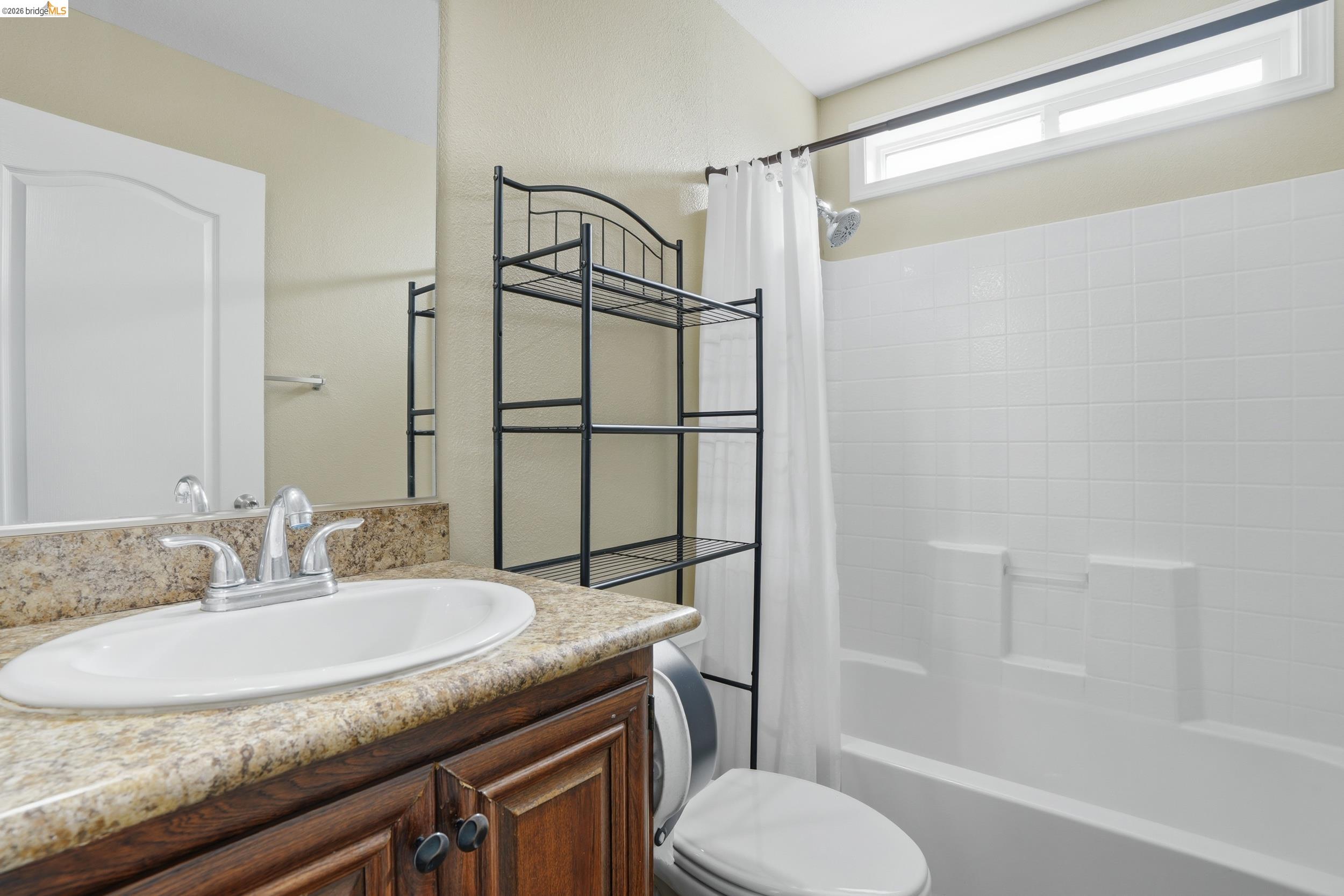 360 East Grant Line Road, Unit SPC 18 Tracy, CA 95376 - Photo 2 of 31 a bathroom with a granite countertop sink toilet and shower