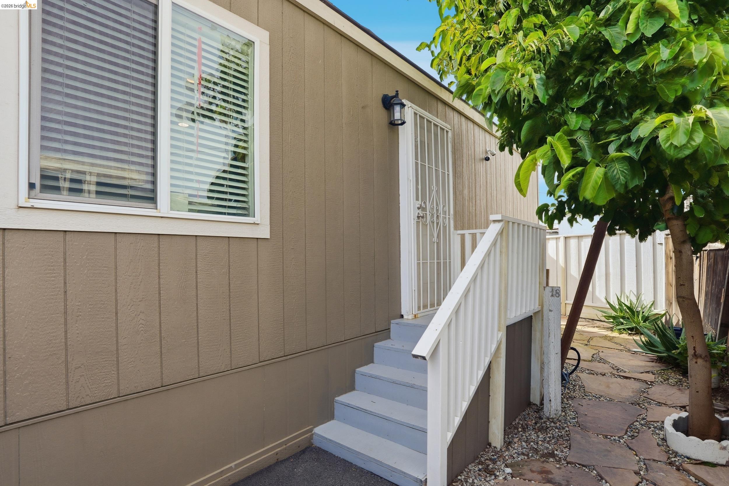 360 East Grant Line Road, Unit SPC 18 Tracy, CA 95376 - Photo 4 of 31 a view of entryway with wooden floor and a potted plant