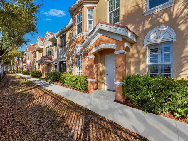 a view of a brick building next to a yard
