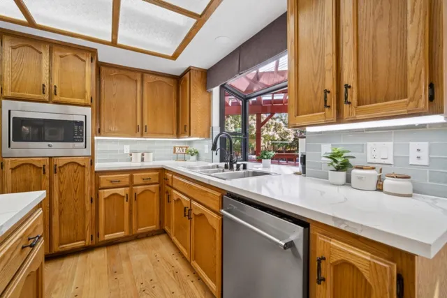 a bathroom with a granite countertop sink toilet and mirror