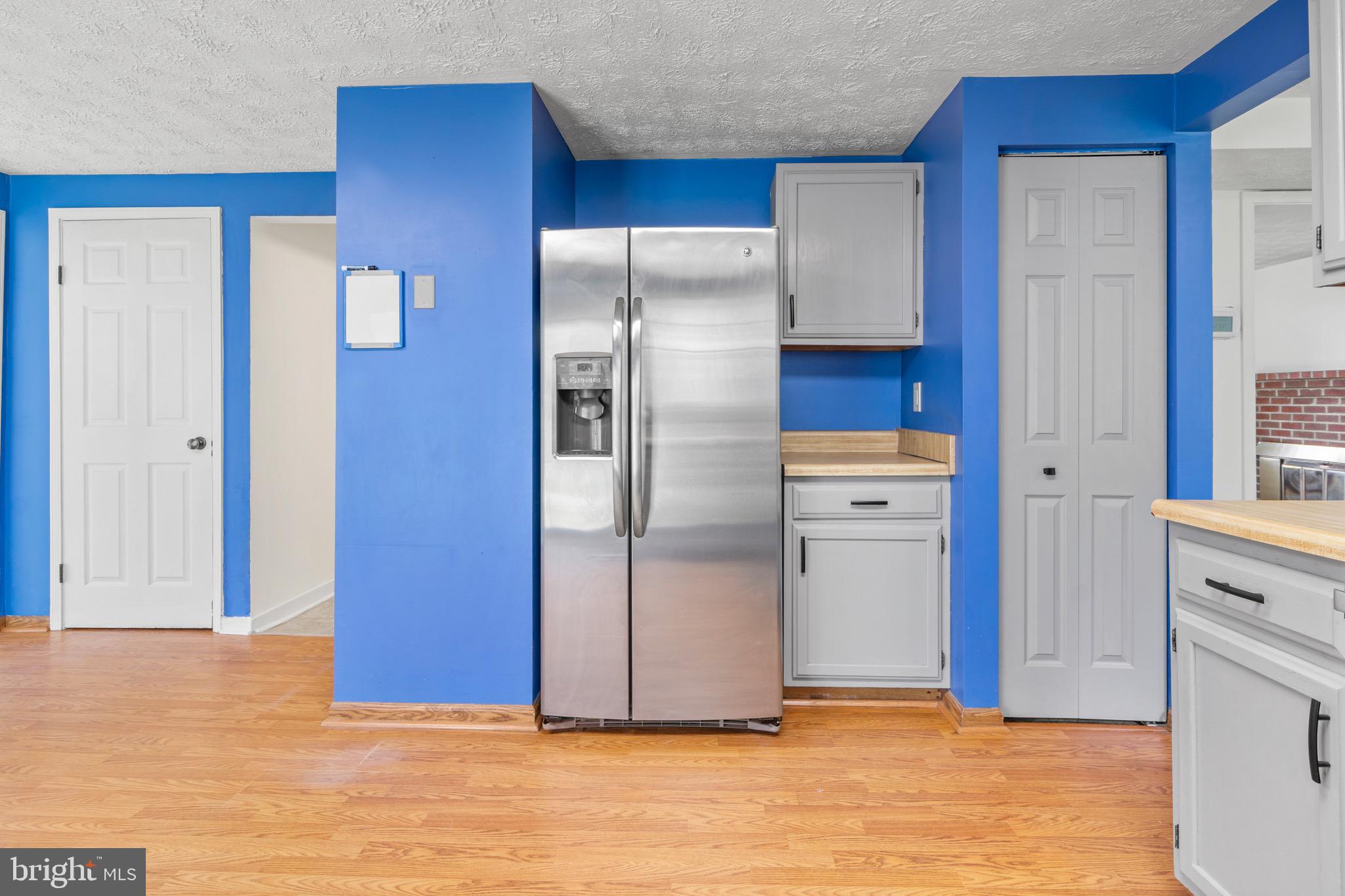 3520 Upton Road Baltimore, MD 21234 - Photo 11 of 39 a view of kitchen with refrigerator cabinets and wooden floor
