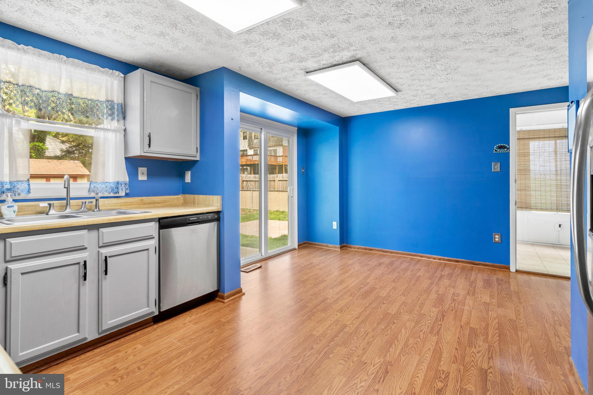 3520 Upton Road Baltimore, MD 21234 - Photo 12 of 39 a kitchen with granite countertop a sink cabinets and wooden floor