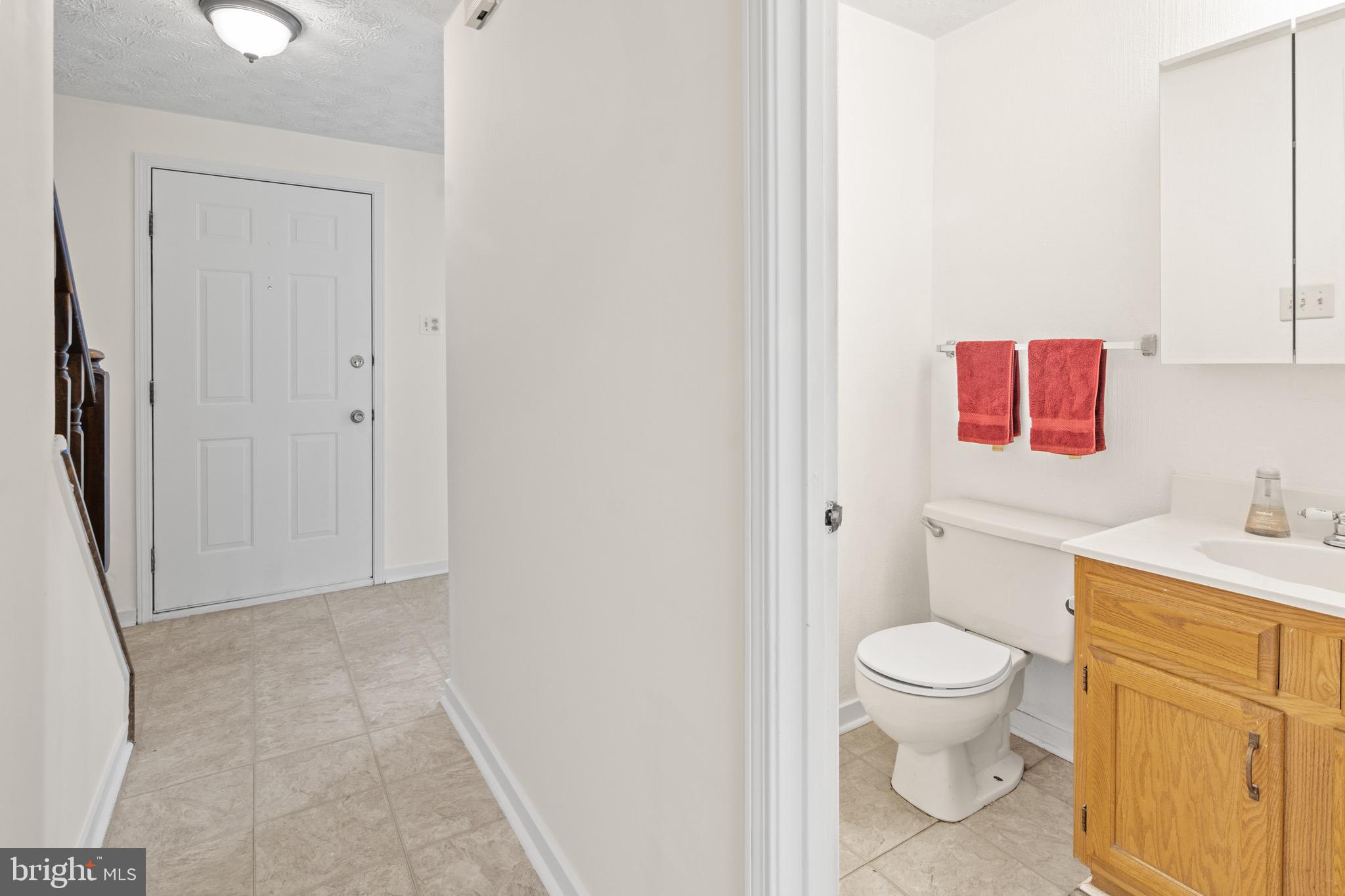 3520 Upton Road Baltimore, MD 21234 - Photo 17 of 39 a white toilet sitting next to a bathroom sink and vanity