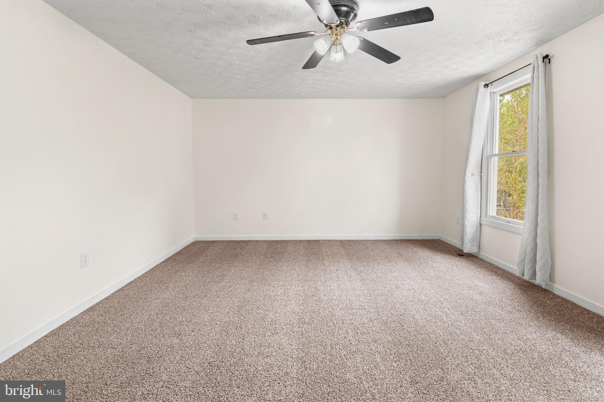 3520 Upton Road Baltimore, MD 21234 - Photo 21 of 39 an empty room with a window and a fan