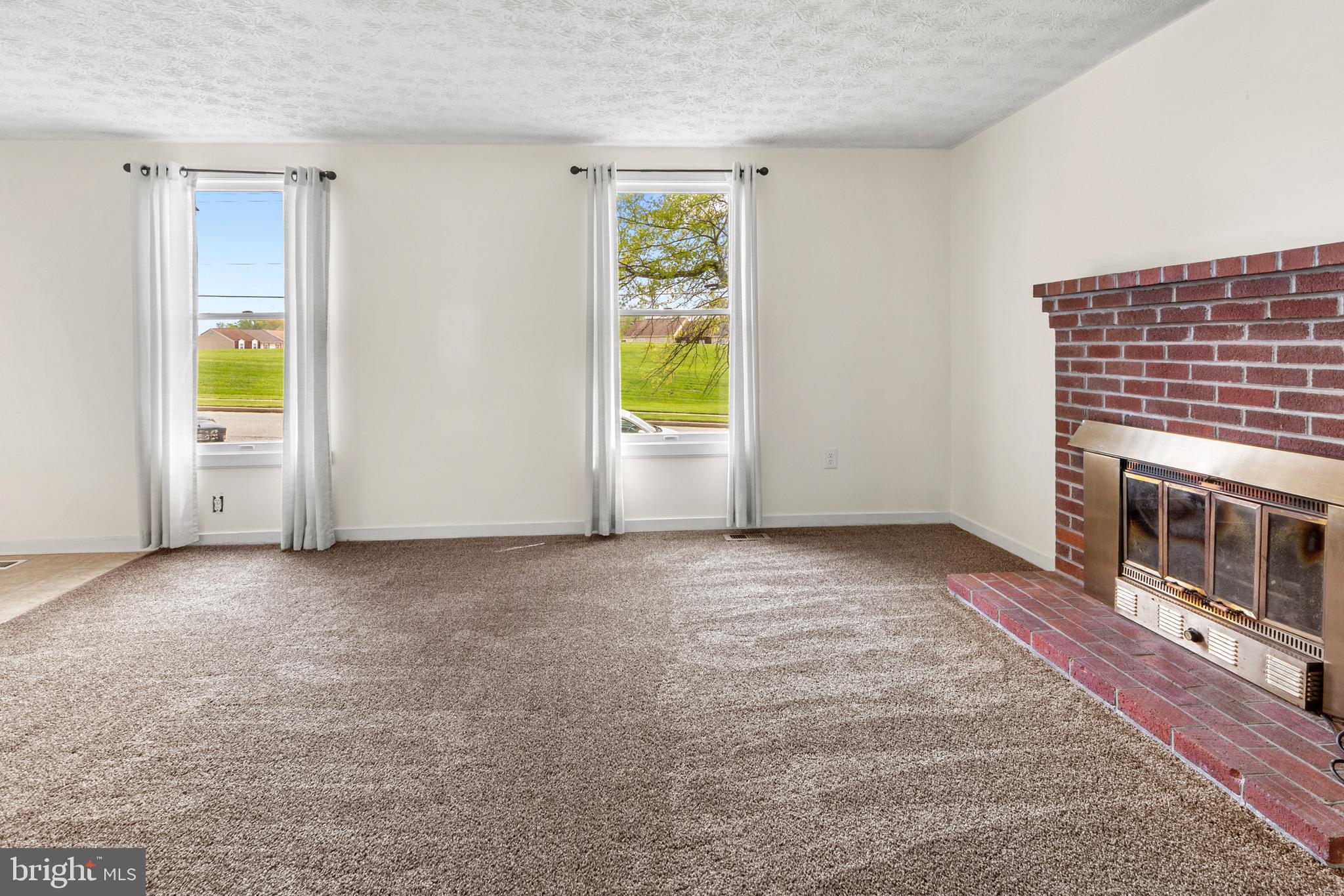3520 Upton Road Baltimore, MD 21234 - Photo 5 of 39 a view of an empty room with a fireplace and a window