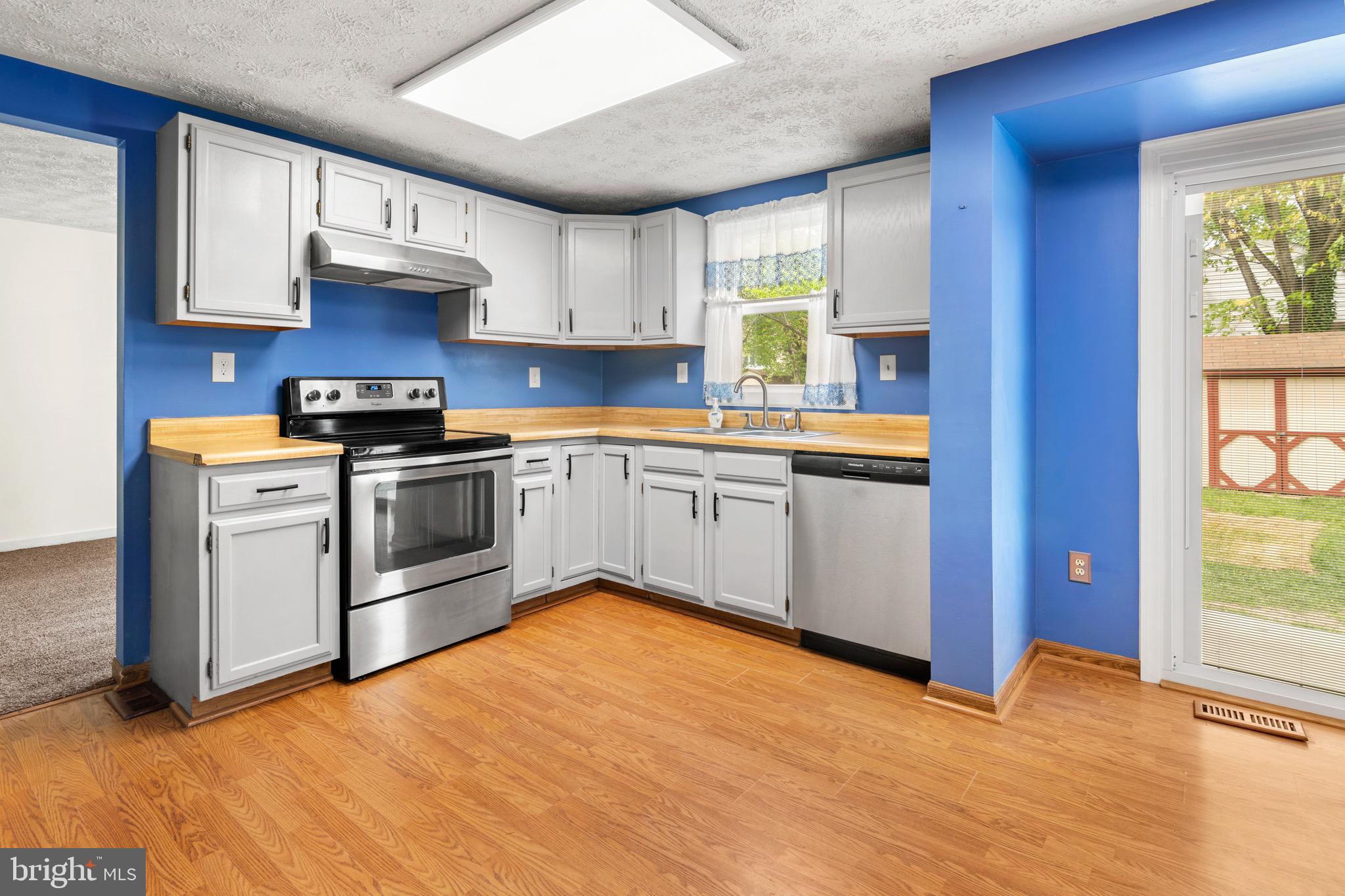 3520 Upton Road Baltimore, MD 21234 - Photo 10 of 39 a kitchen with stainless steel appliances granite countertop a stove sink and cabinets