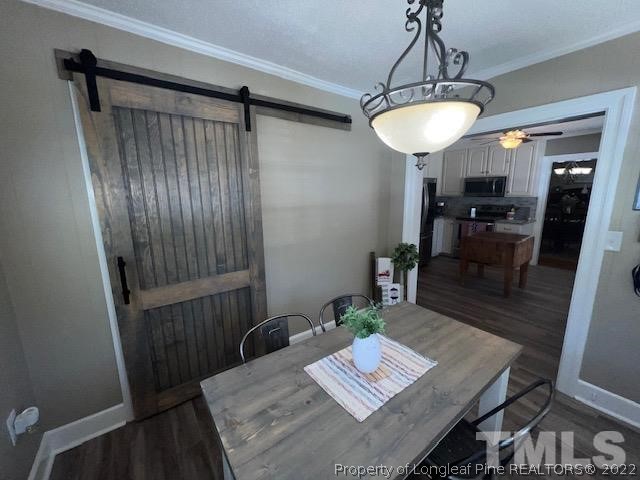 406 Old Post Road Erwin, NC 28339 - Photo 12 of 30 a view of a dining room with furniture and wooden floor