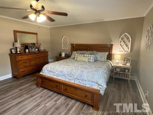 406 Old Post Road Erwin, NC 28339 - Photo 13 of 30 a bedroom with a bed and a chandelier
