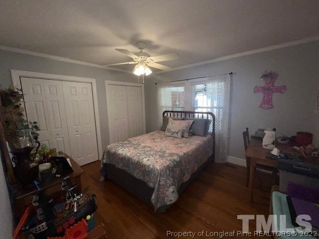 406 Old Post Road Erwin, NC 28339 - Photo 14 of 30 a bedroom with a bed and a chandelier