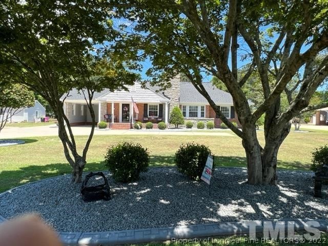 406 Old Post Road Erwin, NC 28339 - Photo 26 of 30 a view of a house with garden space and sitting area