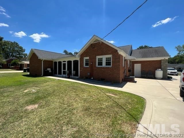 406 Old Post Road Erwin, NC 28339 - Photo 30 of 30 a front view of a house with yard and green space