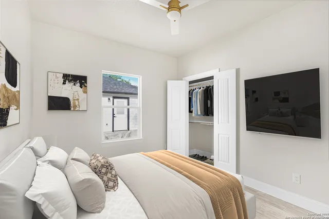 a bedroom with a bed and a flat screen tv