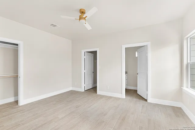 a bathroom with a granite countertop toilet sink and a mirror