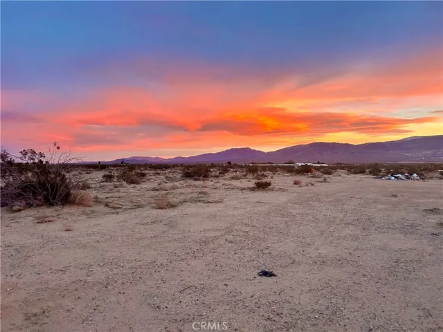 a view of a lake in a field