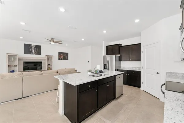a kitchen with lots of clutter and cabinets