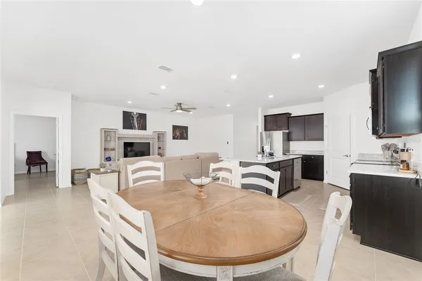 a living room with furniture and a ceiling fan