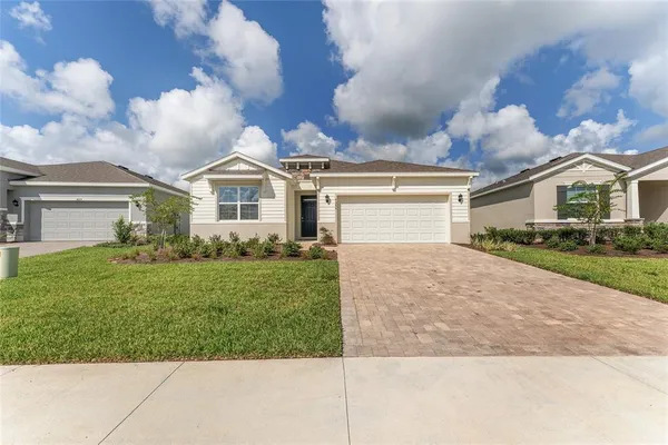 a front view of a house with a yard and garage