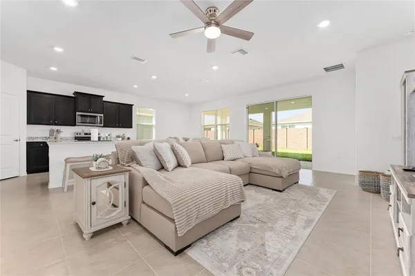 a spacious bedroom with a bed and a chair