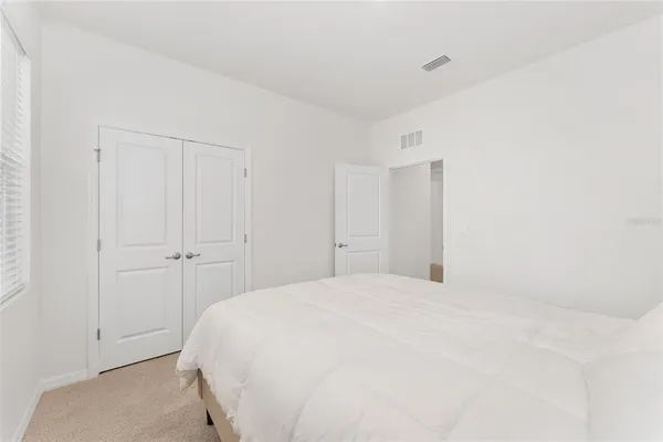 a bedroom with a bed and a view of bathroom