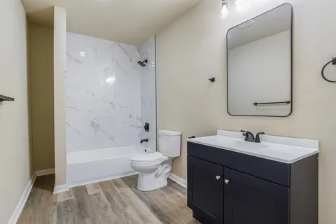 a bathroom with a sink toilet a mirror and shower